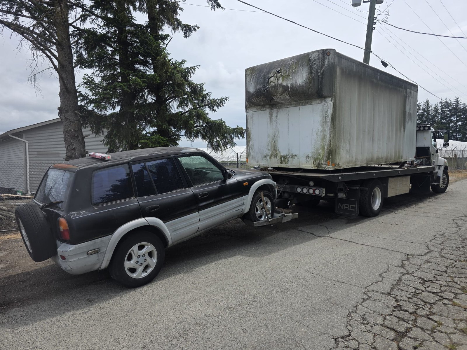 Junk vehicle removal in progress at a Surrey property